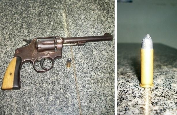 Arma apreendida com o elemento. Ao lado a munição com o formato adulterado
